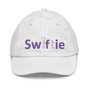 White baseball cap with "Swiftie" embroidered in purple.